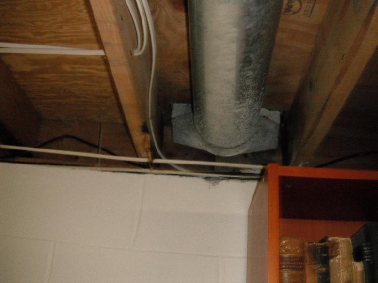 Before: the basement band joists and duct work were unsealed, allowing outdoor air to enter the home.